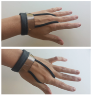 Close-ups of left hand wearing wristband with attached touchscreen and elastic cable over forefinger